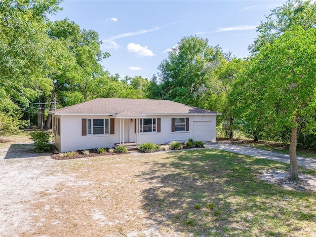 31 Lake Dr, Debary, FL 32713 - ranch-style home featuring driveway, an attached garage, roof with shingles, and view of scattered trees