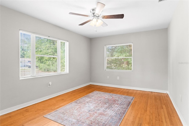 31 Lake Dr, Debary, FL 32713 - unfurnished room with healthy amount of natural light, wood finished floors, a ceiling fan, and baseboards