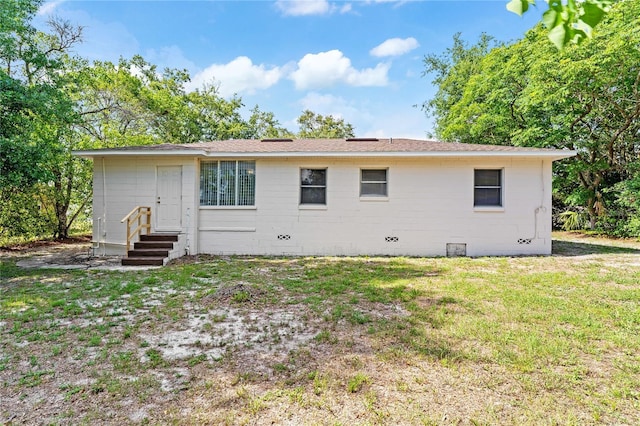 31 Lake Dr, Debary, FL 32713 - rear view of property featuring a lawn and entry steps
