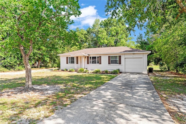 31 Lake Dr, Debary, FL 32713 - ranch-style house featuring a garage, concrete driveway, central AC unit, and a front lawn
