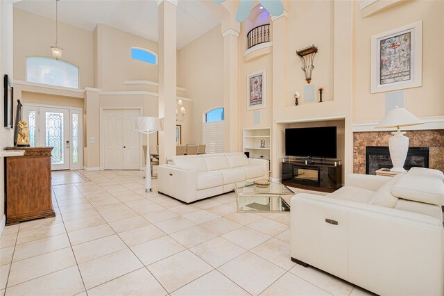 4427 S Atlantic Ave, Port Orange, FL 32127 - living area with a high ceiling, built in shelves, a premium fireplace, light tile patterned floors, and baseboards