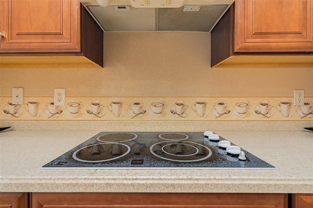 4427 S Atlantic Ave, Port Orange, FL 32127 - kitchen view of light countertops, brown cabinetry, and range hood