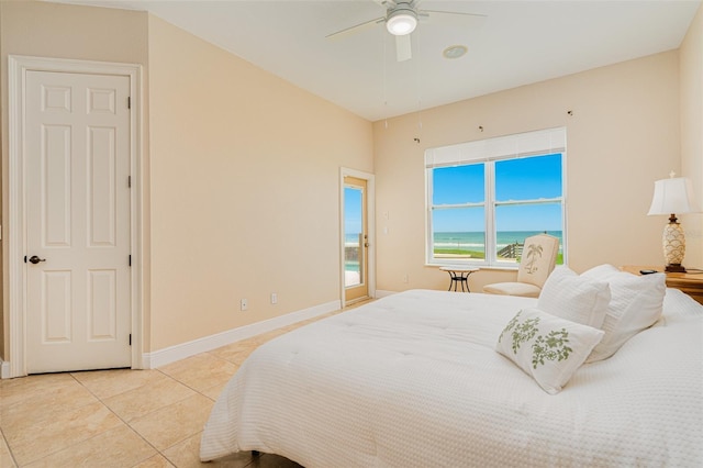 4427 S Atlantic Ave, Port Orange, FL 32127 - bedroom with light tile patterned floors, a water view, a ceiling fan, and baseboards