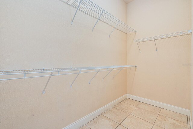 4427 S Atlantic Ave, Port Orange, FL 32127 - walk in closet featuring light tile patterned floors