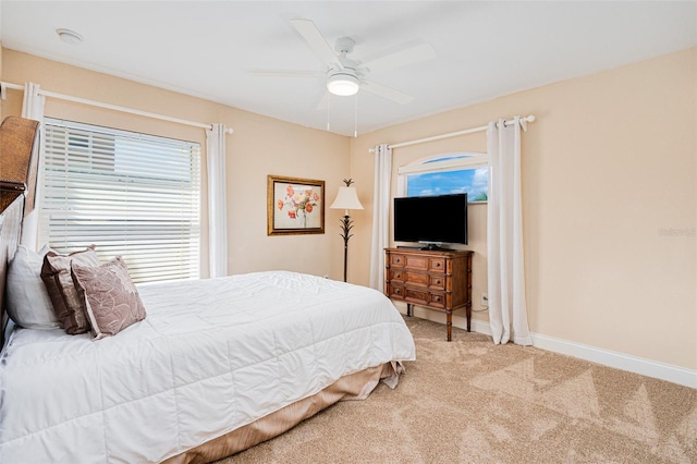 4427 S Atlantic Ave, Port Orange, FL 32127 - bedroom with light carpet, a ceiling fan, and baseboards