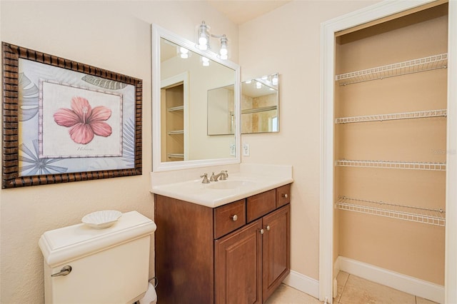 4427 S Atlantic Ave, Port Orange, FL 32127 - bathroom with vanity, toilet, baseboards, and tile patterned floors