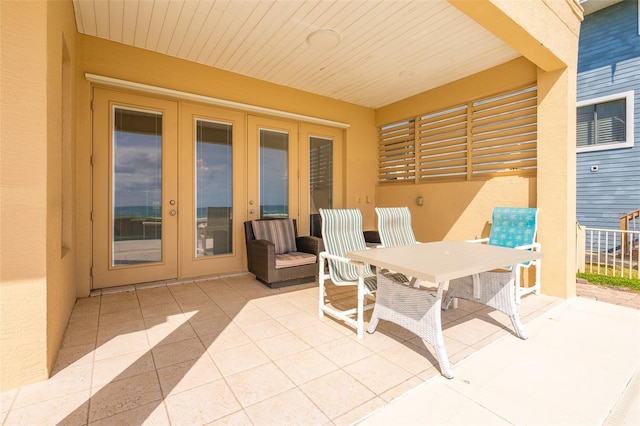 4427 S Atlantic Ave, Port Orange, FL 32127 - view of patio with french doors and outdoor dining space