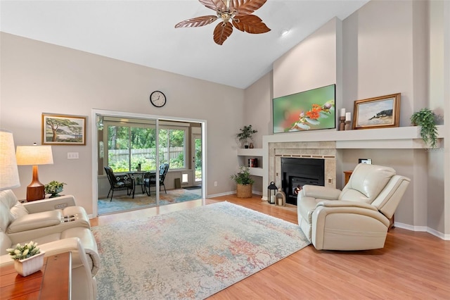 1637 Bent Oaks Blvd, Deland, FL 32724 - living area featuring high vaulted ceiling, ceiling fan, a fireplace with flush hearth, wood finished floors, and baseboards