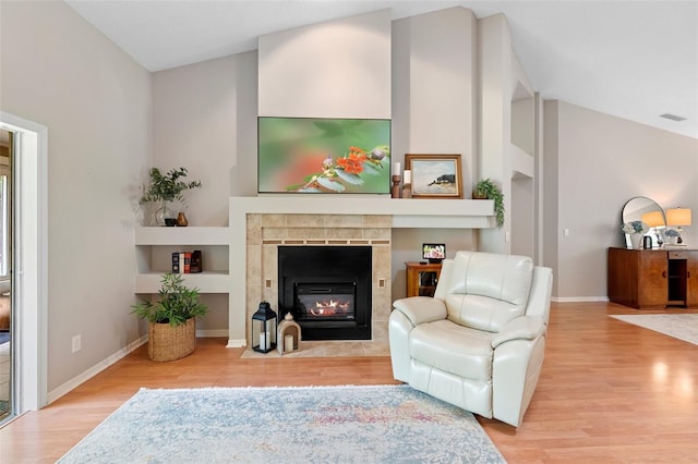 1637 Bent Oaks Blvd, Deland, FL 32724 - living area with wood finished floors, a tiled fireplace, baseboards, and built in features