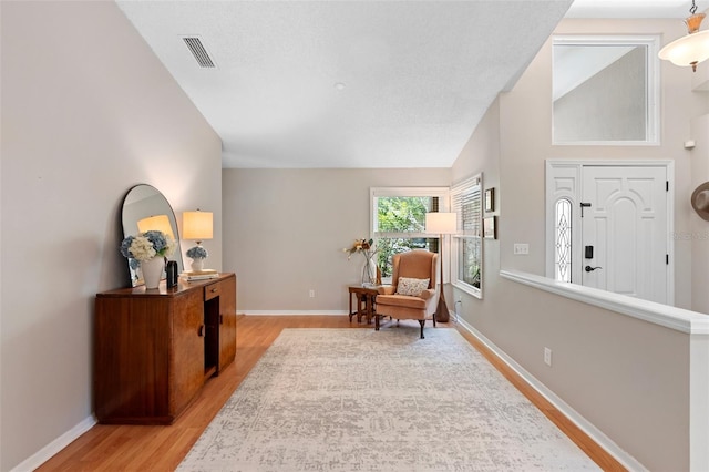 1637 Bent Oaks Blvd, Deland, FL 32724 - sitting room featuring light wood-style floors, baseboards, and vaulted ceiling