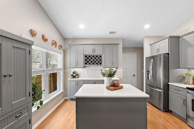 1637 Bent Oaks Blvd, Deland, FL 32724 - kitchen with stainless steel fridge with ice dispenser, gray cabinetry, light countertops, light wood-style flooring, and recessed lighting