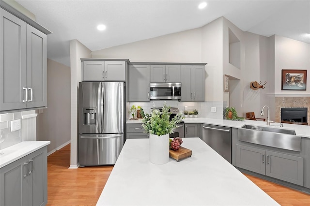 1637 Bent Oaks Blvd, Deland, FL 32724 - kitchen with appliances with stainless steel finishes, gray cabinetry, a sink, lofted ceiling, and light countertops