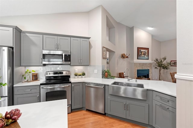 1637 Bent Oaks Blvd, Deland, FL 32724 - kitchen featuring stainless steel appliances, gray cabinets, a sink, light countertops, and tasteful backsplash