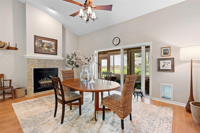 1637 Bent Oaks Blvd, Deland, FL 32724 - dining room featuring light wood-style floors, a ceiling fan, a fireplace, baseboards, and high vaulted ceiling