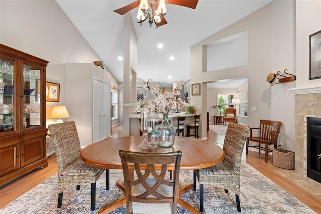 1637 Bent Oaks Blvd, Deland, FL 32724 - dining room with a ceiling fan, light wood finished floors, a fireplace, high vaulted ceiling, and recessed lighting