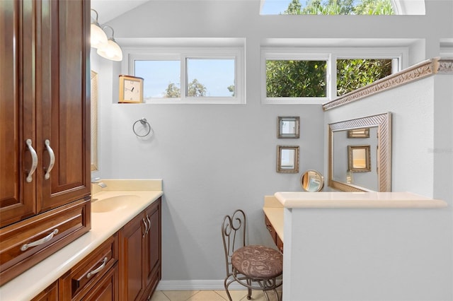 1637 Bent Oaks Blvd, Deland, FL 32724 - bathroom with healthy amount of natural light, vanity, tile patterned floors, vaulted ceiling, and baseboards