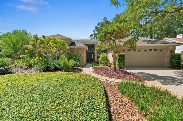1637 Bent Oaks Blvd, Deland, FL 32724 - view of front of house with a garage, concrete driveway, and brick siding