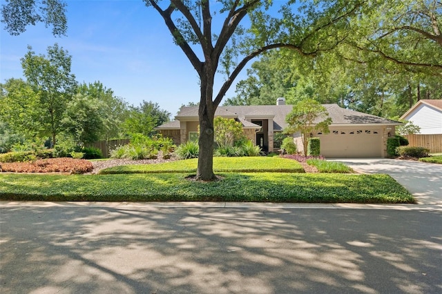1637 Bent Oaks Blvd, Deland, FL 32724 - mid-century modern home featuring a garage, driveway, and a chimney
