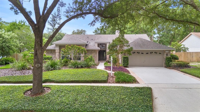 1637 Bent Oaks Blvd, Deland, FL 32724 - single story home with a garage, a chimney, concrete driveway, and roof with shingles