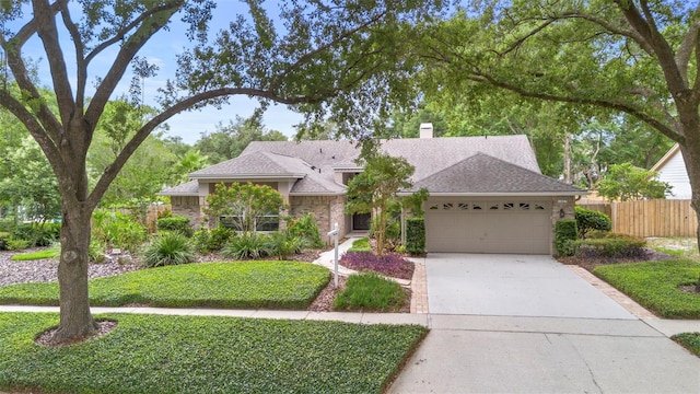 1637 Bent Oaks Blvd, Deland, FL 32724 - ranch-style home featuring an attached garage, a chimney, concrete driveway, and a shingled roof