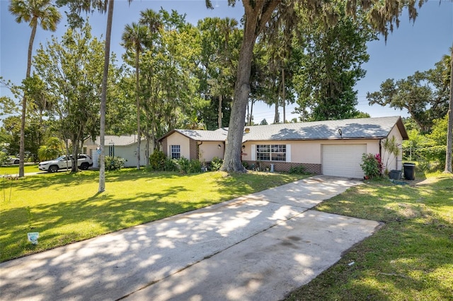 5 Greenfern Cir, Ormond Beach, FL 32174 - single story home with concrete driveway, an attached garage, a front yard, stucco siding, and brick siding