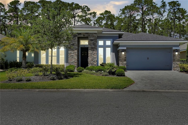 344 Stirling Bridge Dr, Ormond Beach, FL 32174 - prairie-style home with stone siding, driveway, an attached garage, and a front yard