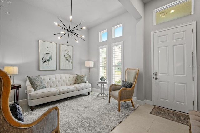 344 Stirling Bridge Dr, Ormond Beach, FL 32174 - living room with a chandelier, a towering ceiling, light tile patterned floors, and baseboards