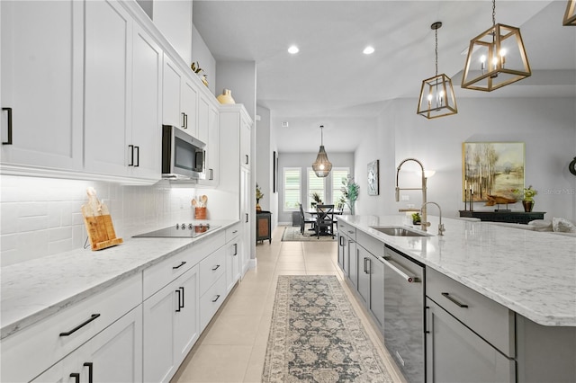 344 Stirling Bridge Dr, Ormond Beach, FL 32174 - kitchen featuring stainless steel appliances, a sink, recessed lighting, tasteful backsplash, and white cabinetry