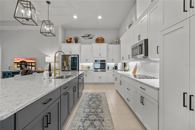 344 Stirling Bridge Dr, Ormond Beach, FL 32174 - kitchen featuring appliances with stainless steel finishes, white cabinetry, decorative backsplash, recessed lighting, and pendant lighting