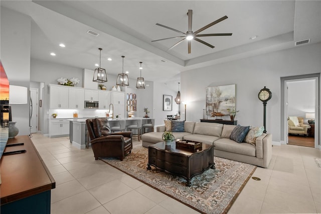 344 Stirling Bridge Dr, Ormond Beach, FL 32174 - living area featuring a ceiling fan, light tile patterned floors, a tray ceiling, recessed lighting, and baseboards