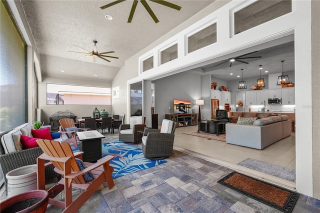 344 Stirling Bridge Dr, Ormond Beach, FL 32174 - living room featuring a ceiling fan and a textured ceiling