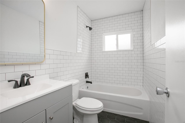 2215 Lake Ruby Rd, Deland, FL 32724 - bathroom featuring tile walls, vanity, toilet,  shower combination, and tile patterned flooring
