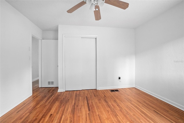 2215 Lake Ruby Rd, Deland, FL 32724 - unfurnished bedroom featuring baseboards, wood finished floors, a closet, and ceiling fan