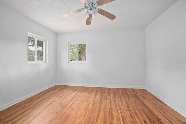 2215 Lake Ruby Rd, Deland, FL 32724 - unfurnished room with light wood-type flooring, baseboards, a ceiling fan, and a textured ceiling