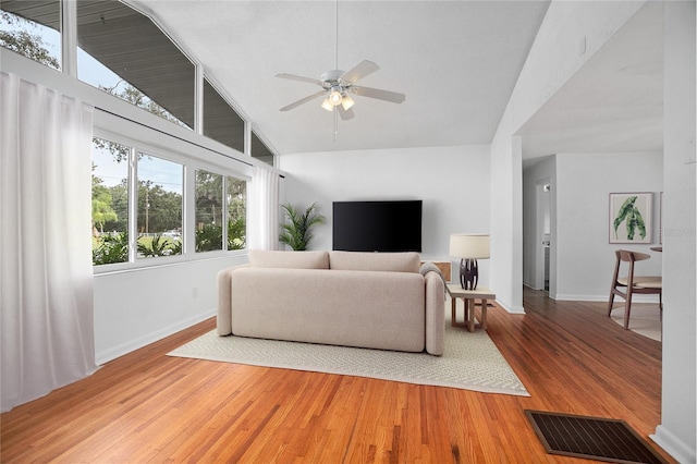 2215 Lake Ruby Rd, Deland, FL 32724 - living room with a ceiling fan, baseboards, high vaulted ceiling, and light wood-style flooring