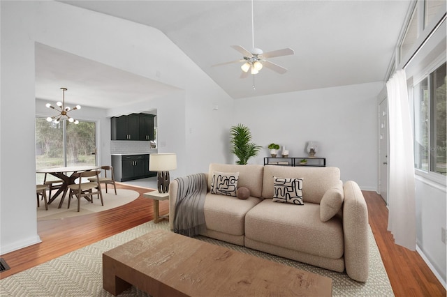 2215 Lake Ruby Rd, Deland, FL 32724 - living room featuring light wood finished floors, lofted ceiling, a chandelier, and ceiling fan