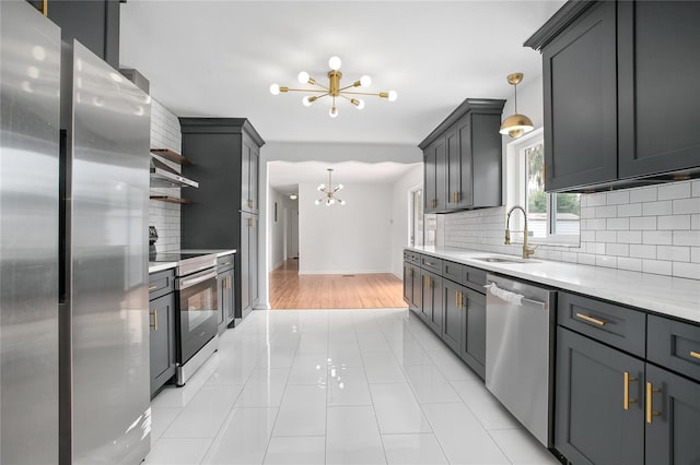 2215 Lake Ruby Rd, Deland, FL 32724 - kitchen featuring appliances with stainless steel finishes, a chandelier, a sink, open shelves, and decorative backsplash