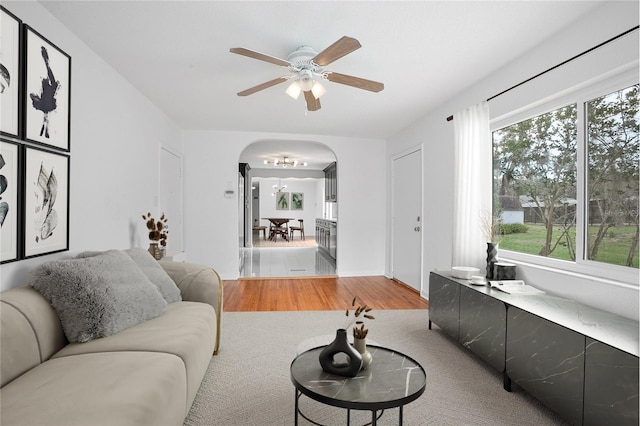 2215 Lake Ruby Rd, Deland, FL 32724 - living area featuring arched walkways, light wood finished floors, and ceiling fan