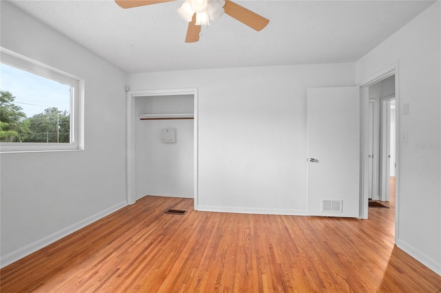 2215 Lake Ruby Rd, Deland, FL 32724 - unfurnished bedroom with light wood-style flooring, baseboards, ceiling fan, and a closet