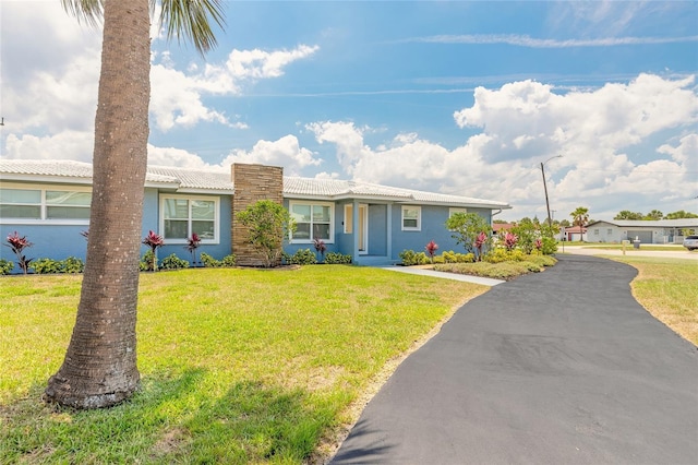 1032 Bel Aire Dr, Daytona Beach, FL 32118 - single story home with a front lawn and stucco siding