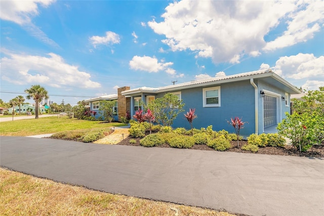 1032 Bel Aire Dr, Daytona Beach, FL 32118 - ranch-style house with a front lawn and a chimney