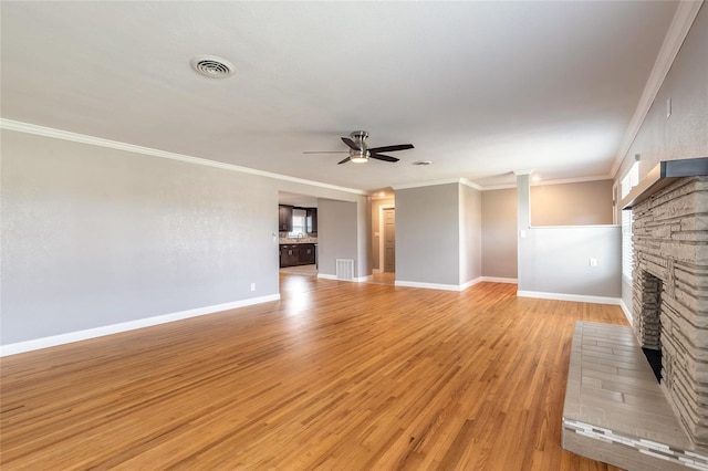 1032 Bel Aire Dr, Daytona Beach, FL 32118 - unfurnished living room featuring a fireplace with raised hearth, a ceiling fan, light wood-style flooring, ornamental molding, and baseboards