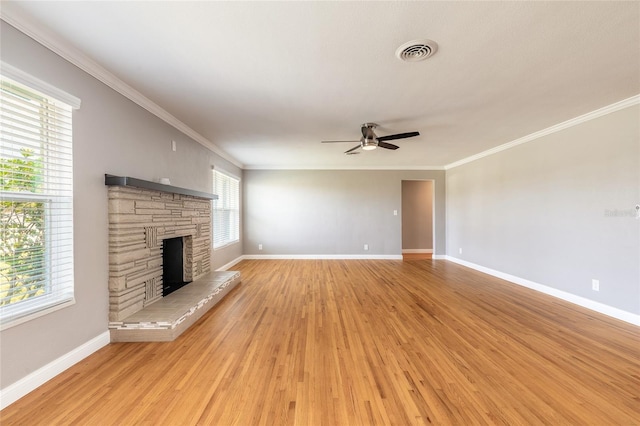 1032 Bel Aire Dr, Daytona Beach, FL 32118 - unfurnished living room with light wood finished floors, baseboards, a fireplace, ceiling fan, and crown molding