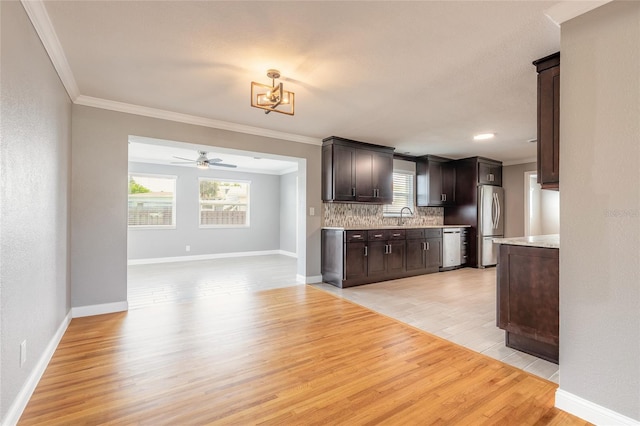 1032 Bel Aire Dr, Daytona Beach, FL 32118 - kitchen featuring appliances with stainless steel finishes, ornamental molding, a ceiling fan, dark brown cabinets, and light wood finished floors