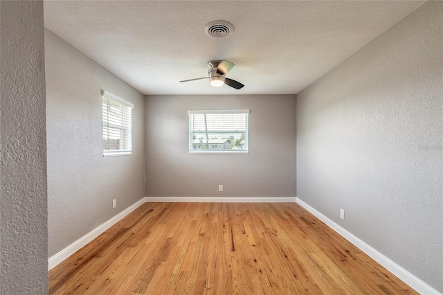 1032 Bel Aire Dr, Daytona Beach, FL 32118 - spare room with a textured wall, light wood-type flooring, baseboards, and a ceiling fan