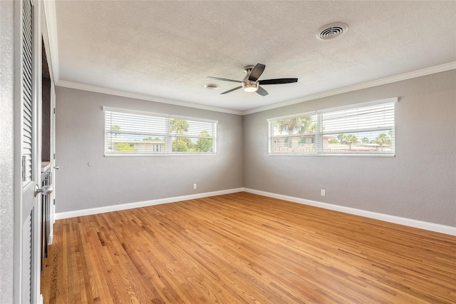 1032 Bel Aire Dr, Daytona Beach, FL 32118 - empty room featuring a textured ceiling, light wood-style floors, crown molding, a ceiling fan, and baseboards