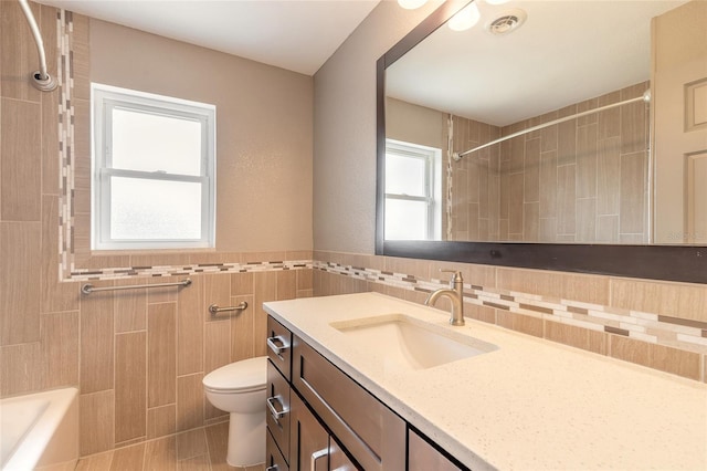 1032 Bel Aire Dr, Daytona Beach, FL 32118 - full bath featuring tile walls, vanity, toilet, shower / bath combination, and tile patterned flooring