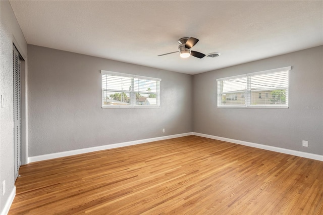 1032 Bel Aire Dr, Daytona Beach, FL 32118 - unfurnished room featuring light wood-style floors, baseboards, and ceiling fan