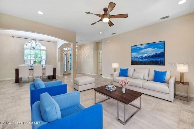 675 Easton Forest Cir SE, Palm Bay, FL 32909 - living room featuring arched walkways, a chandelier, baseboards, a ceiling fan, and recessed lighting