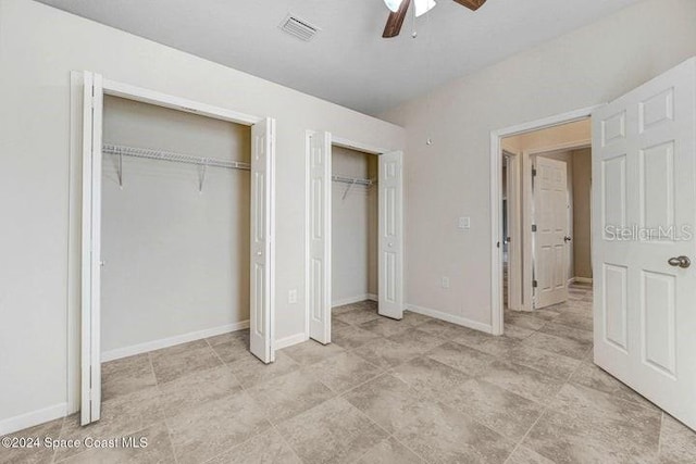 675 Easton Forest Cir SE, Palm Bay, FL 32909 - unfurnished bedroom featuring multiple closets, ceiling fan, and baseboards